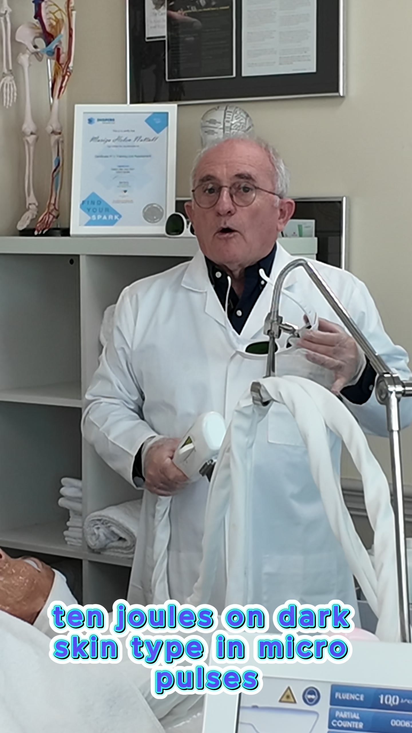 Trainer explaining XLASE handpiece in workshop